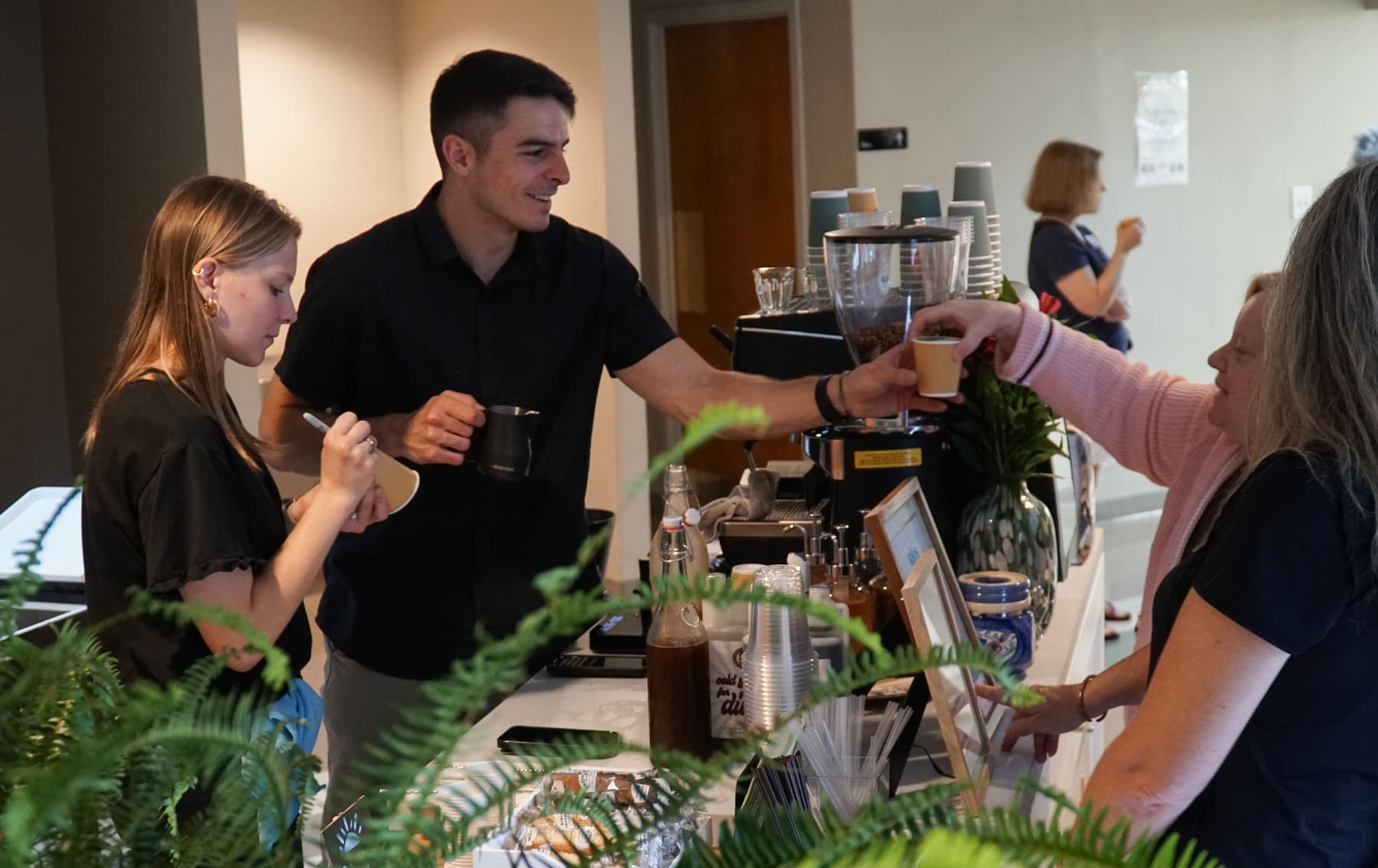 A finished drink passed to a guest at the cart